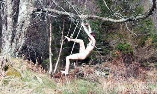 这是怎么了？一女子全裸倒挂在树上